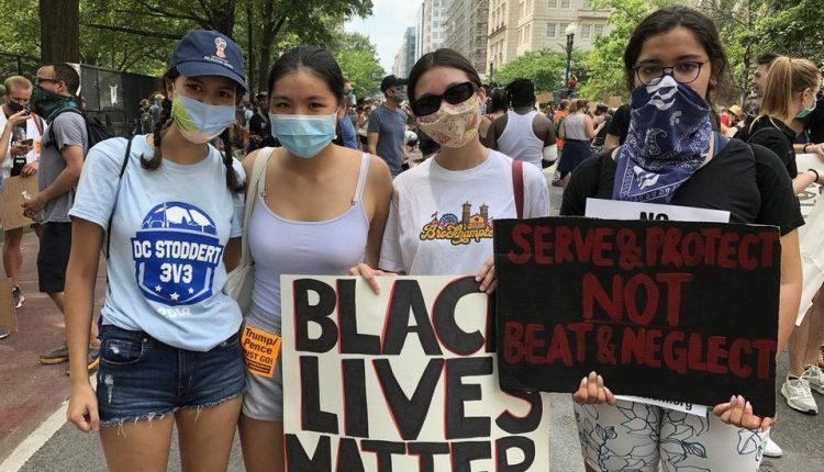 A few girls standing and hold boards